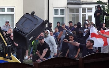 Riot police hold back protesters