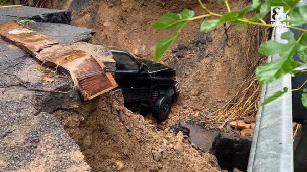 A vehicle tumbled into a sinkhole that opened on a road in Juniata County.