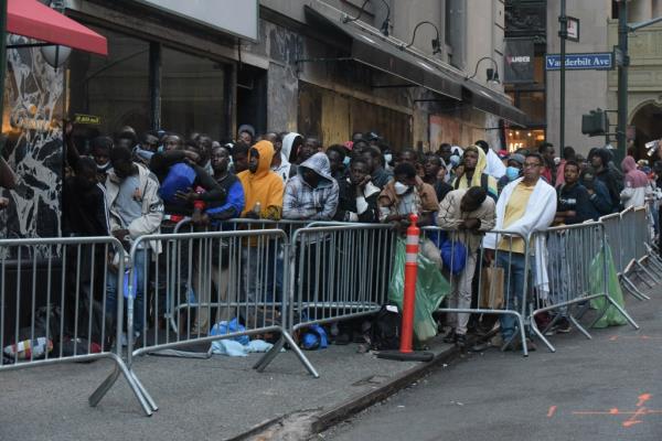Migrants lined up outside of the shelter at the Roosevelt Hotel  on August 8, 2023.