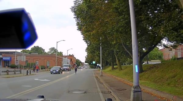 The officer running back to the car. 