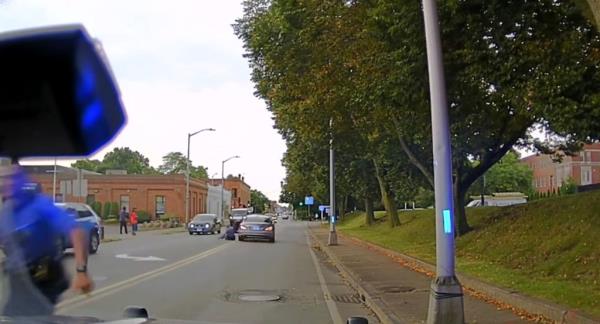 The officer being dragged down road. 