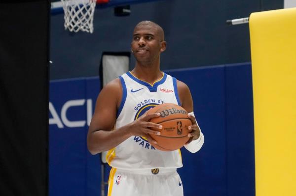 Warriors' Chris Paul poses for photos during the NBA basketball team's media day