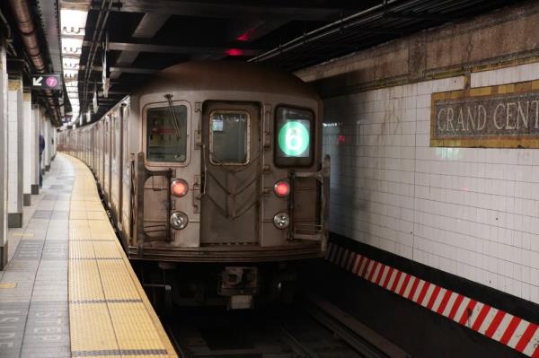 A Number six train arriving at a station