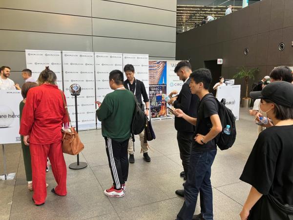 People line up to use WorldCoin's iris-scanners in Tokyo on Tuesday.