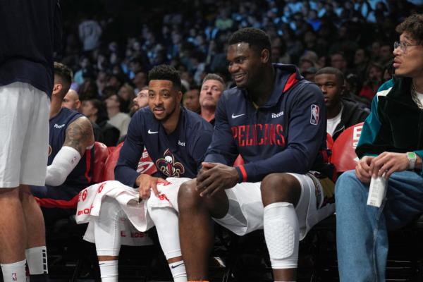 Zion Williamson and CJ McCollum sit on the bench in 2022 against the Nets.