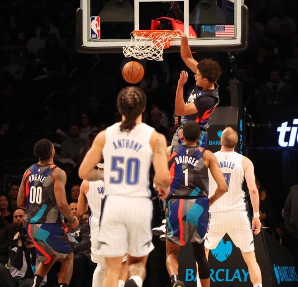 Cam Johnson slams home a dunk during the Nets' victory over the Magic.