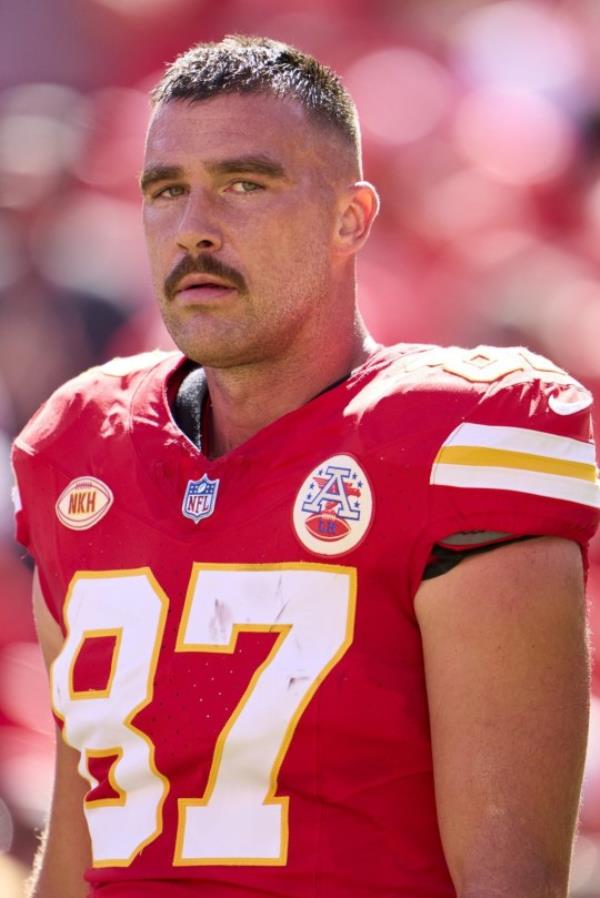 American footballer Travis Kelce of the Kansas City Chiefs looks on before kickoff against the Chicago Bears at GEHA Field at Arrowhead Stadium .
