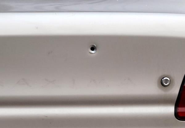 A bullet hole in a car.