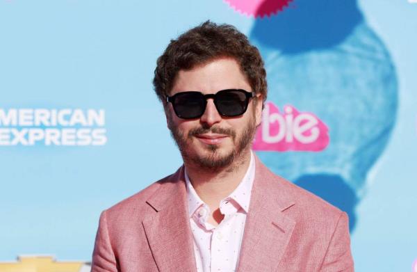 Michael Cera wears a pink suit and sunglasses while promoting 