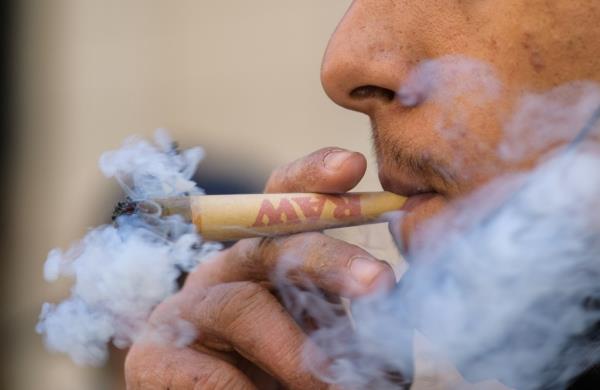 An activist smokes marijuana
