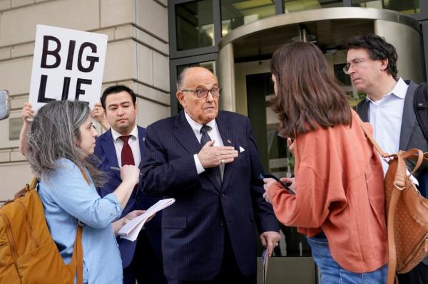 Rudy Giuliani speaks with reporters as he departs the federal courthouse, Friday, May 19, 2023,