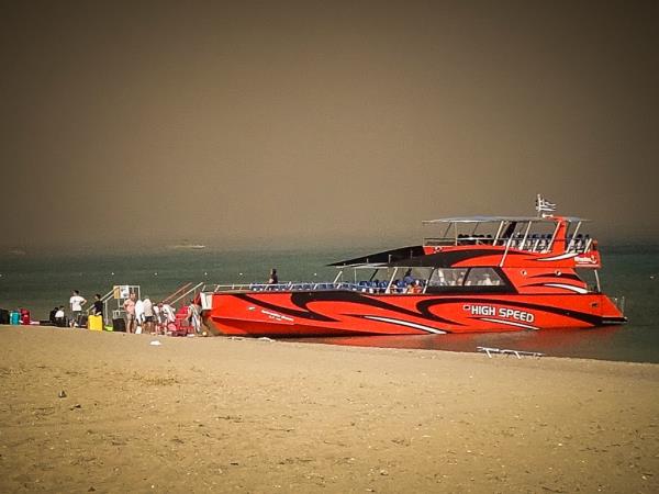 Tourists wait on Rhodes beach to be evacuated