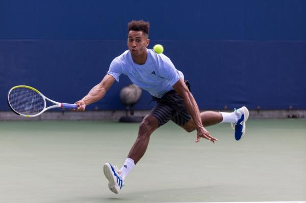 Michael Mmoh of the USA returns to Karen Khachanov of Russia during their first round 2023 US Open Tennis tournament
