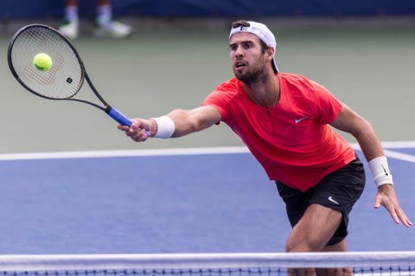 Karen Khachanov of Russia returns to Michael Mmoh of the USA during their first round 2023 US Open Tennis tournament