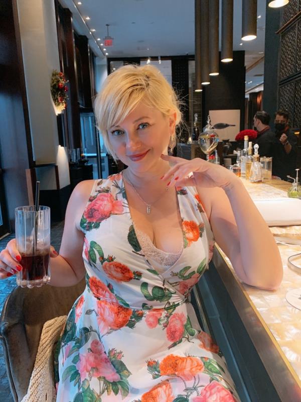 Artist Tatyana Burika in a floral dress.