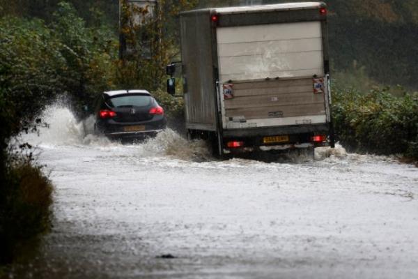 DUMBARTON, UNITED KINGDOM - OCTOBER 07: Members of the public struggle with flooding as torrential rain co<em></em>ntinues on October 07, 2023 in Dumbarton, United Kingdom. The UK is experiencing two very different weather fro<em></em>nts today with temperatures in the South reaching up to 27 degrees Celsius but amber warnings for torrential rain being issued for Scotland. (Photo by Jeff J Mitchell/Getty Images)