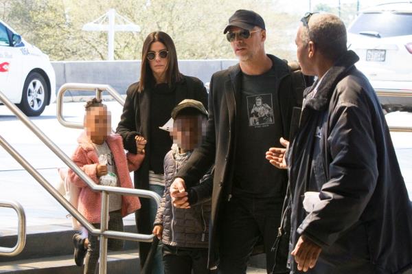 EXCLUSIVE: Sandra Bullock and her children, Louis and Laila, are accompanied by 'boyfriend' Bryan Randall and her bodyguard through Louis Armstrong Internatio<em></em>nal Airport in New Orleans, Louisiana