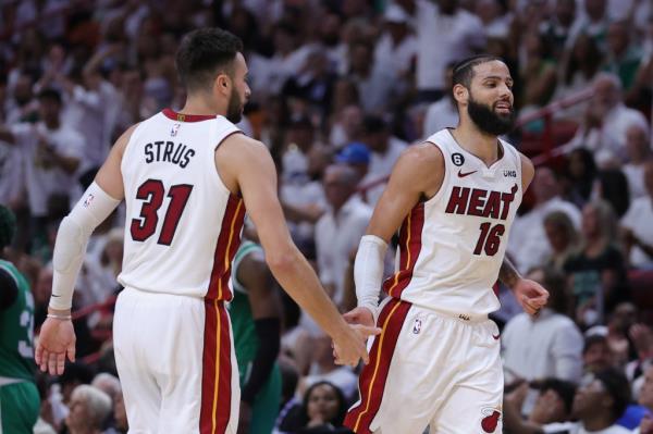 Max Strus #31 and Caleb Martin #16 of the Miami Heat high five against the Boston Celtics.