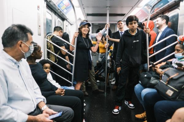 Gov. Kathy Hochul waves to straphangers as she rides an uptown 4/5 train this month. 