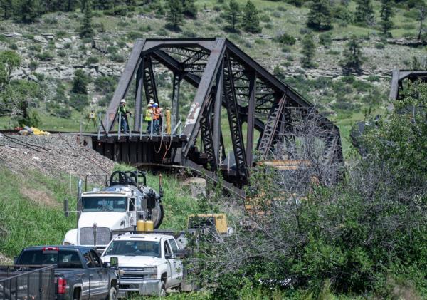 Crews work the site of a railroad bridge that collapsed the day before on the Yellowstone River 