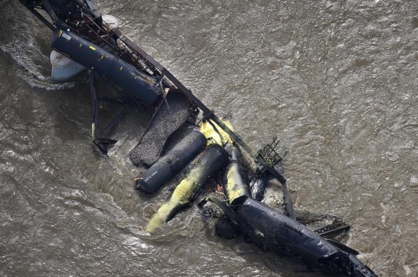 Portions of a freight train are seen in the Yellowstone River after an overnight railroad bridge collapse, near Columbus, Mont., Saturday, June 24, 2023. 