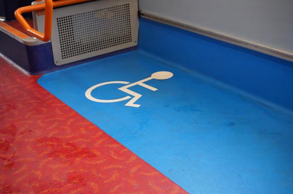 Disabled blue and white sign on floor of a public transport bus
