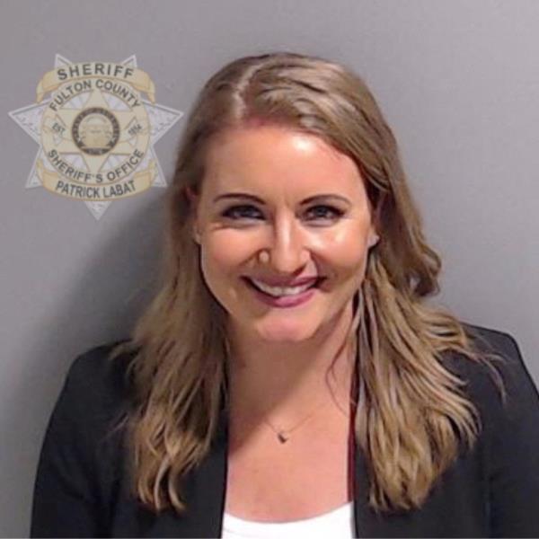 Jenna Ellis reacts with her lawyers after reading a statement pleading guilty to one felony count of aiding and abetting false statements and writings inside Fulton Superior Court Judge Scott McAfee's Fulton County Courtroom in Atlanta, Georgia, on October 24, 2023.