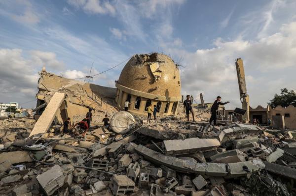 Palestinians inspect the ruins of a destroyed mosque in the city of Khan Yunis, south of the Gaza Strip, following an Israeli airstrike on the second day of the o<em></em>ngoing co<em></em>nflict between Israel and the Palestinian militant group Hamas.