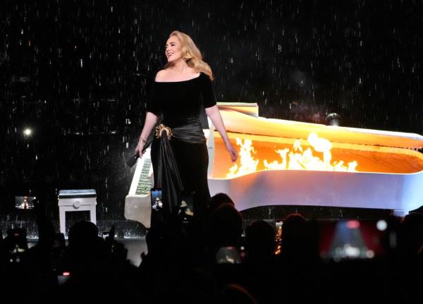 Adele on stage with piano on fire