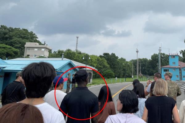 Travis King was seen standing at the DMZ with a tour group moments before he sprinted across the border into detention