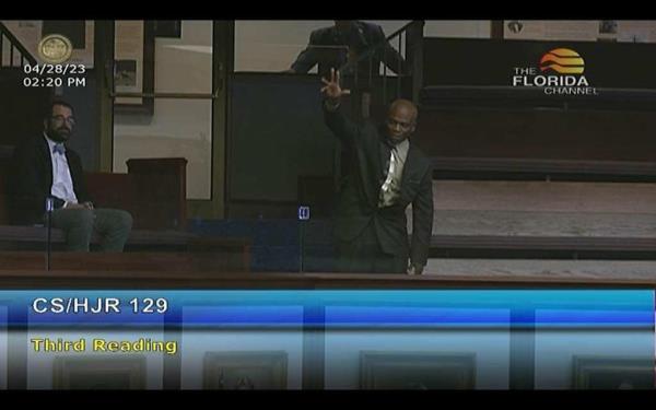 Leo<em></em>nard Cure raises a hand in a courtroom video screenshot