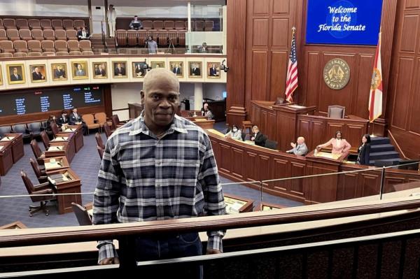 Leo<em></em>nard Cure stands on the balcony of the Florida state senate chambers.
