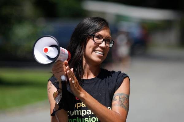 Kristin Mink, a local organizer and candidate for Mo<em></em>ntgomery County Council talks to supporters of the Drag Queen Story Hour kids reading program at the Kensington Branch of the Mo<em></em>ntgomery Co. Libraries.