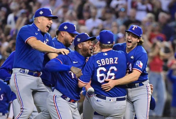 Rangers players mobbing pitcher Josh Sborz after he recorded the final out of the game.