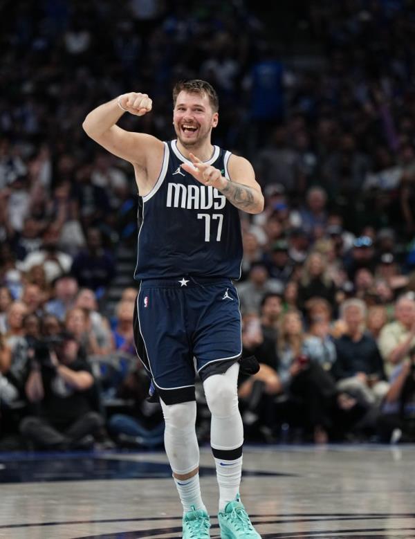 Luka Do<em></em>ncic #77 of the Dallas Mavericks celebrates during a game against the Brooklyn Nets with his fist in the air.