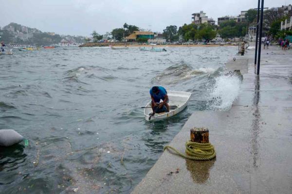 A man moors his boat in Acapulco, Guerrero State, Mexico, on August 16, 2023, following the passage of Tropical Storm Hilary.