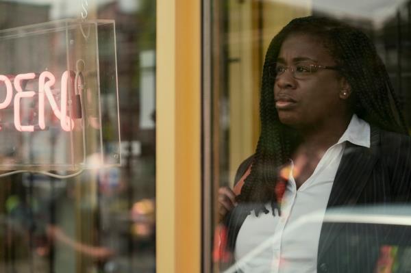 Uzo Aduba looking through a window. 