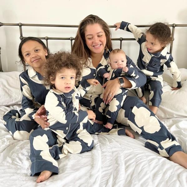 Jess Jo<em></em>nes in matching pyjamas with all four of her children