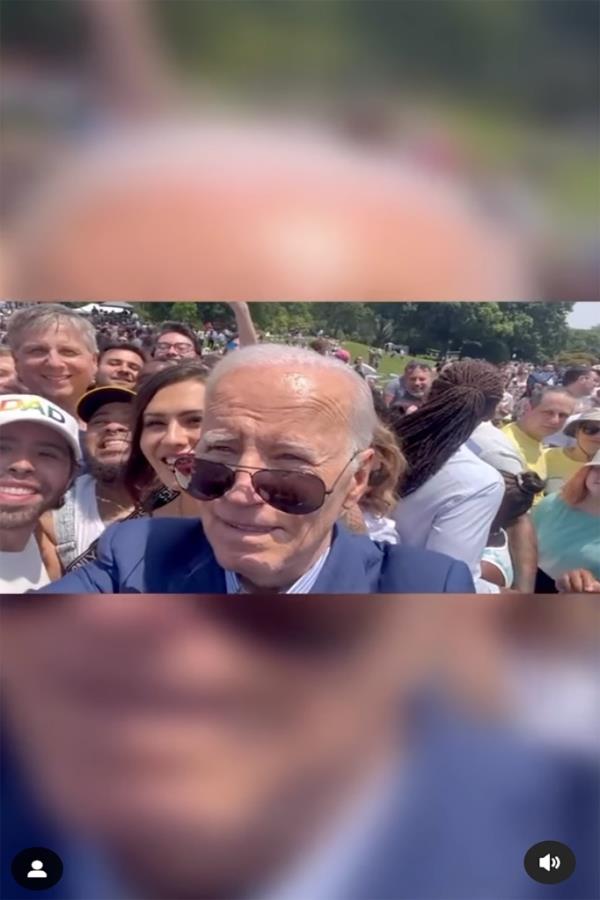 Biden is seen mistakenly taking a video of Mo<em></em>ntoya and others which was meant to be a photo.