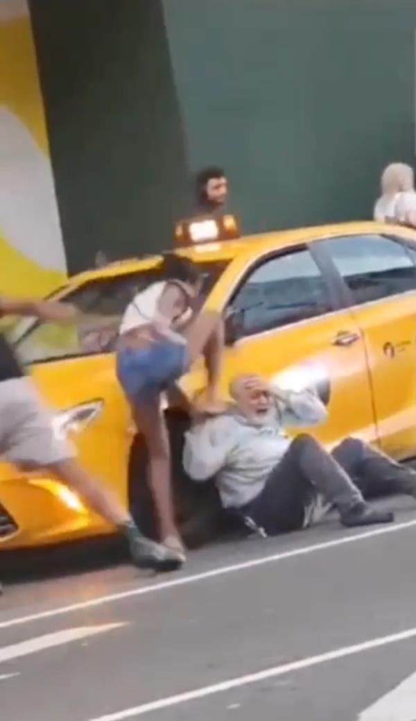 Group attacks cab driver on street.