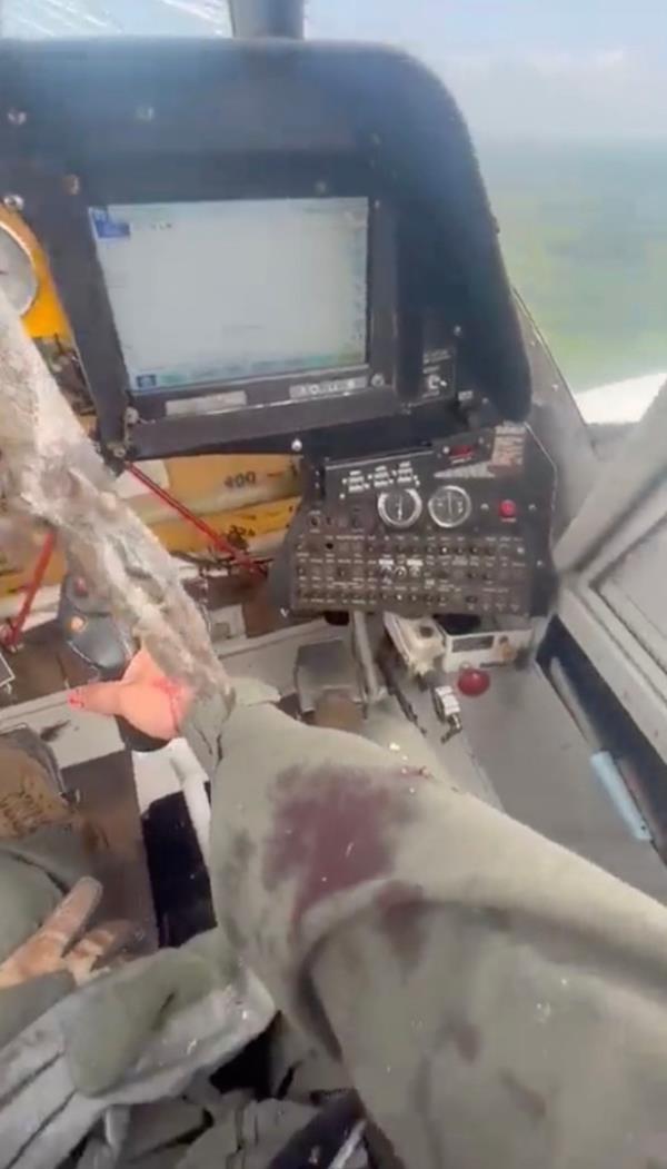 Pilot holds stick with bird dangling