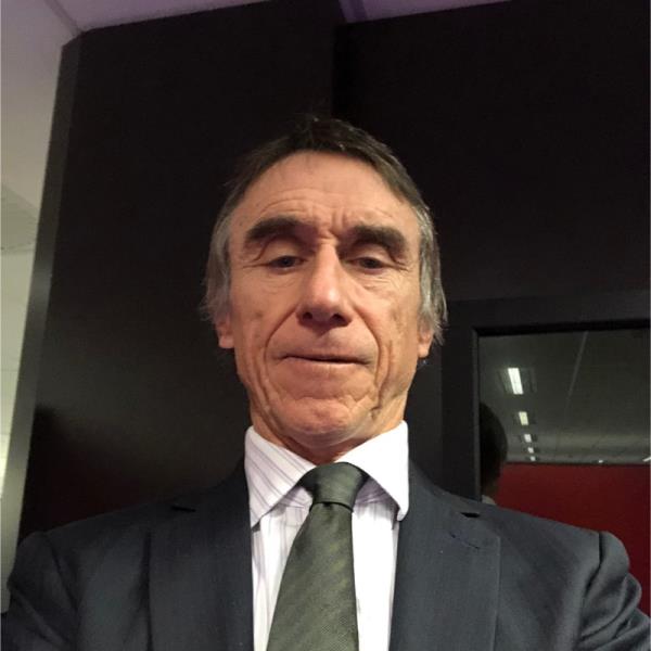 Photo of a man in a gray suit. 