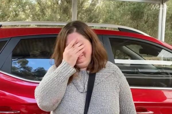 Photo of a woman with her hands covering her face. 