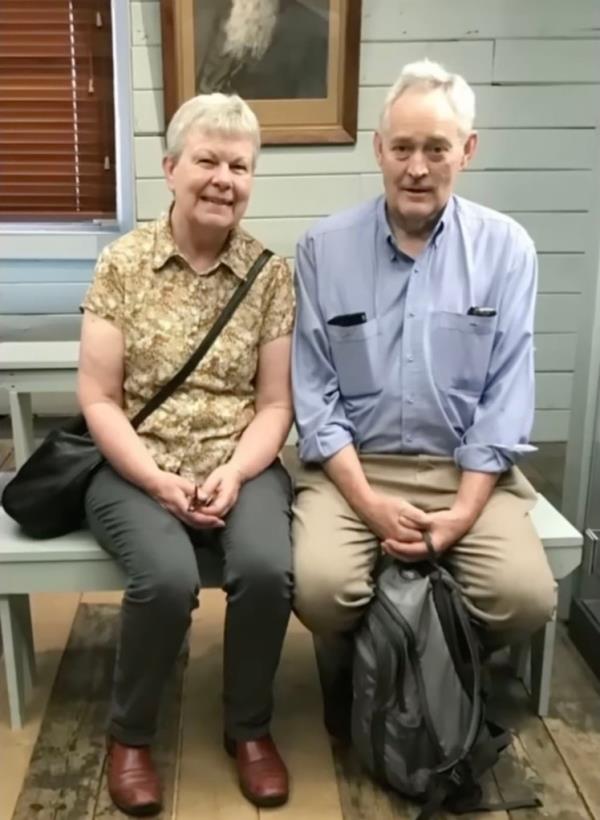 Photo of two older people sitting down together. 