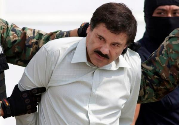 ‘El Chapo’ Guzman, the head of Mexico’s Sinaloa Cartel, is escorted to a helicopter in Mexico City in 2014 (Picture: AP)