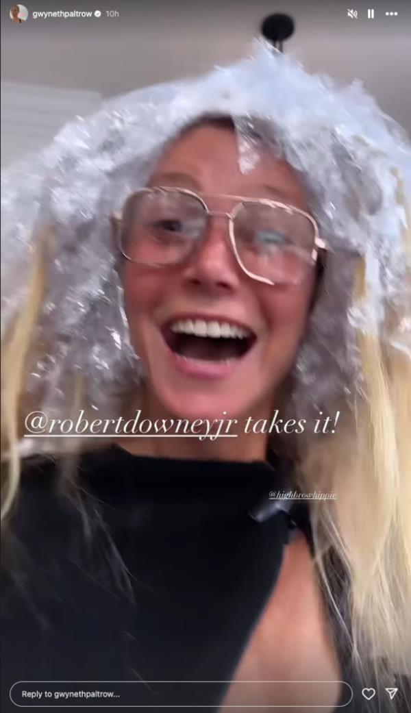 Jubilant with her friend's win, Paltrow turns the camera around and gives fans a brief glimpse of herself sporting a black coverup with several sheets of tin foil in her hair all the while sporting her infamous spectacles.