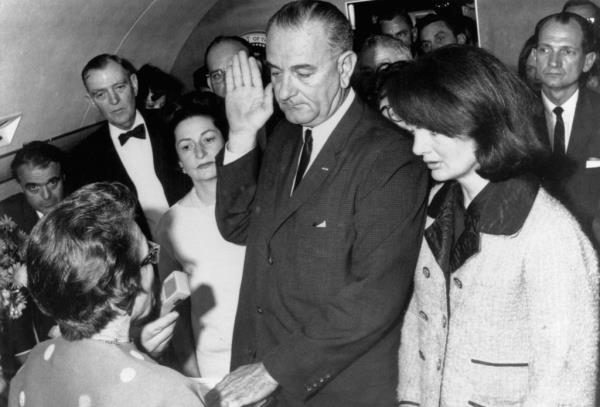 Vice President Lyndon B Johnson is sworn in to the office of the Presidency aboard Air Force One in Dallas, Texas, hours after the assassination of President Kennedy on Nov. 22, 1963.