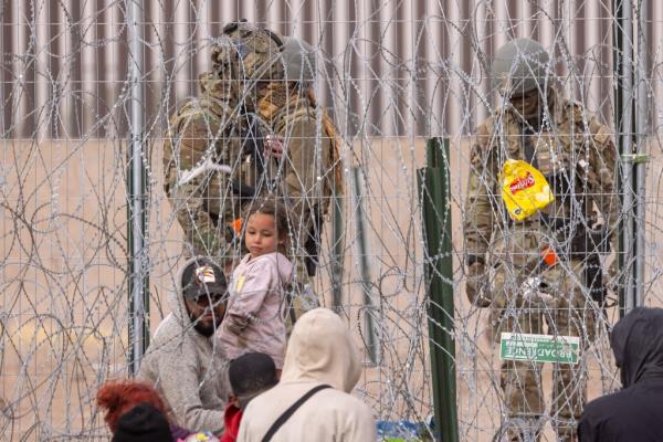 Migrants pictured at the border with the Natio<em></em>nal Guard