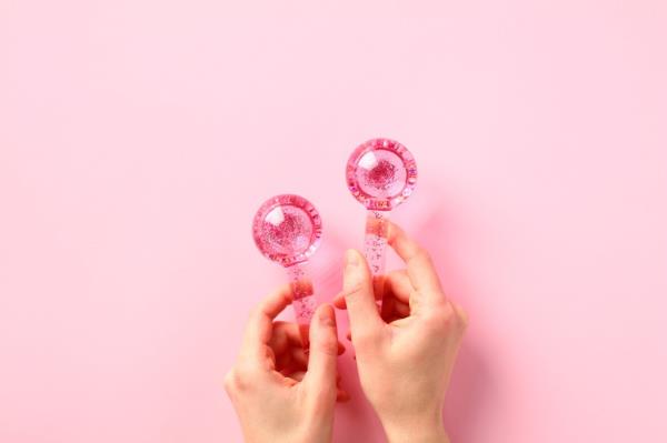Person holding pink ice rollers