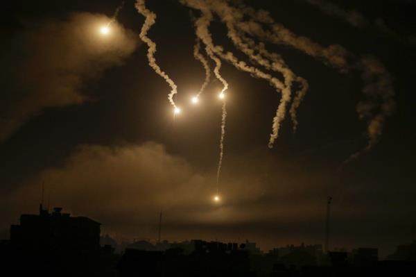 Israeli army flares illuminate the sky over northern Gaza City, on Oct. 31, 2023. 